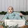 baby, blue, buttoned_sweater, child, cozy, crate, cute, expression, floor, greenery, hat, indoors, infant, knitwear, person, plant, portrait, seated, wooden_box, young