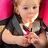 Adhara is registered to the contest to win money with this photo: baby, black_shirt, blue_jeans, car_seat, child, cute, face, hair_tie, indoors, infant, pacifier, pink_bow, portrait, safety, seatbelt, sitting, small_hands, sunlight, toddler, young_child