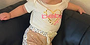 Adhara joined the competition — help win amazing prizes! toddler, child, girl, cute, smile, bow, hair, shirt, shorts, shoes, couch, leather, indoor, pose, fashion, golden, white, pink, happy, young