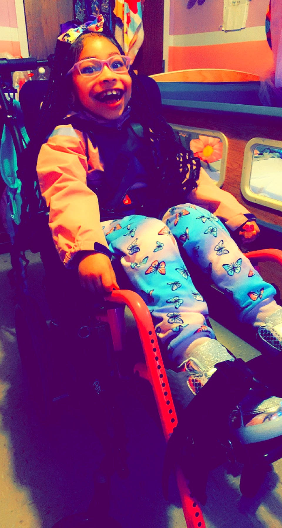 Genevieve is registered to the contest to win money with this photo: bag, bumper, child, cool, electric_blue, entertainment, fun, happy, human_leg, knee, leisure, magenta, pattern, person, recreation, sitting, smile, thigh