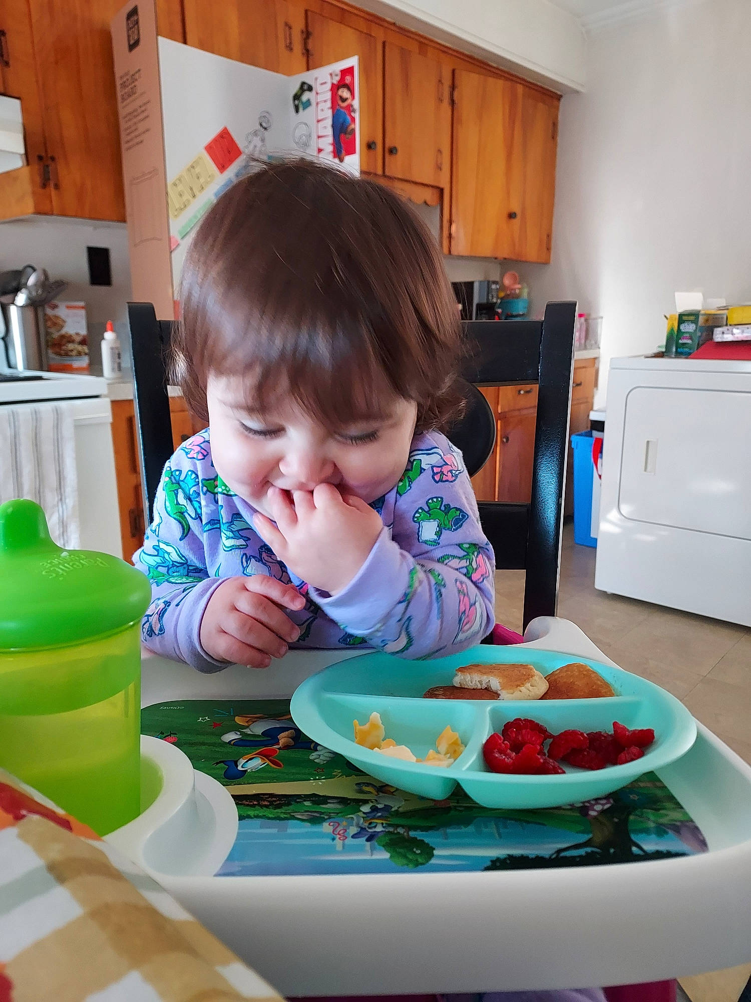 Rangeley is registered to the contest to win money with this photo: baby, cabinetry, chair, child, comfort_food, dishware, drawer, drinkware, food, kitchen_appliance, person, plate, refrigerator, room, serveware, sharing, sitting, spoon, table, tableware