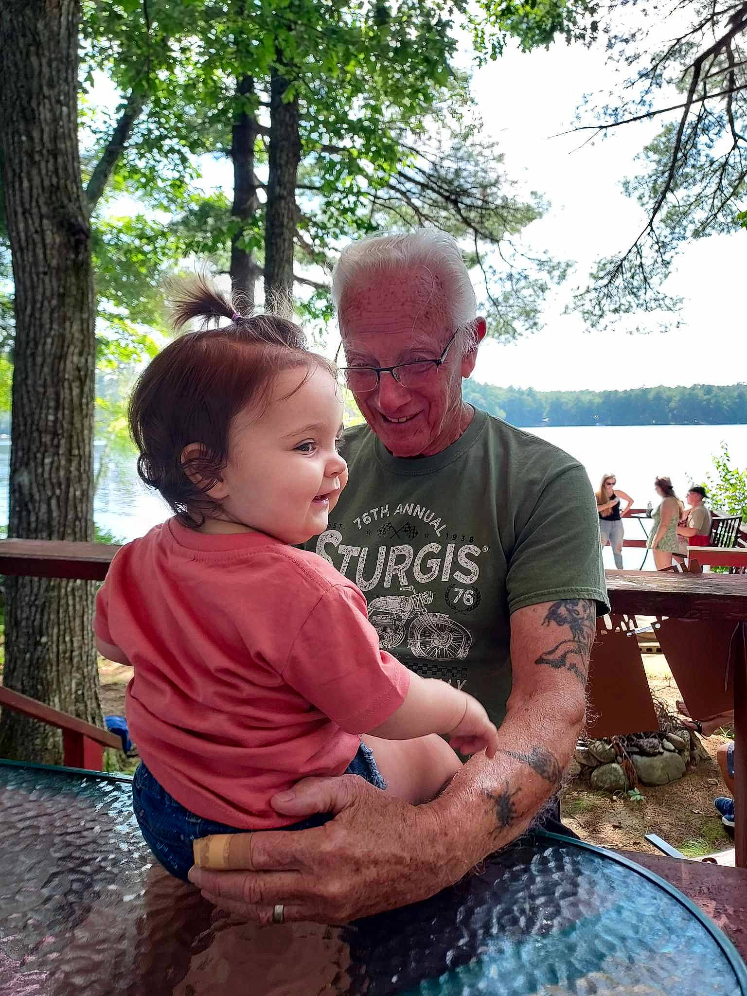 Rangeley joined the competition — help win amazing prizes! baby, child, event, fun, grass, happy, joy, leisure, person, plant, recreation, sitting, sky, smile, spring, summer, t_shirt, table, toddler, tree