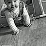 baby, child, crawling, smiling, playpen, toy, soft_toy, floor, indoors, black_and_white, portrait, cute, infant, clothing, hand, face, head, eyes, expression, baby_girl