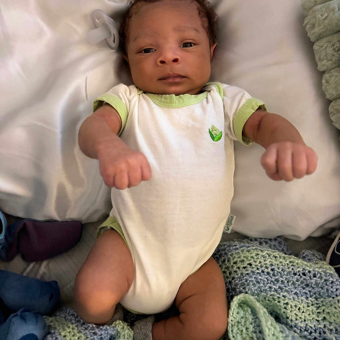 Adam is registered to the contest to win money with this photo: baby, baby_clothes, blanket, child, cozy, cute, fist, indoors, infant, infant_boy, knitted_blanket, lying_down, newborn, onesie, pacifier, person, portrait, resting, sleeping_area, soft_texture