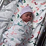 Morgan is registered to the contest to win money with this photo: newborn, baby, infant, sleeping, hospital, bassinet, blanket, swaddled, hat, lavender, portrait, face, closed_eyes, peaceful,  의료, footprints, medical_setting, indoors, bedding, newborn_photography