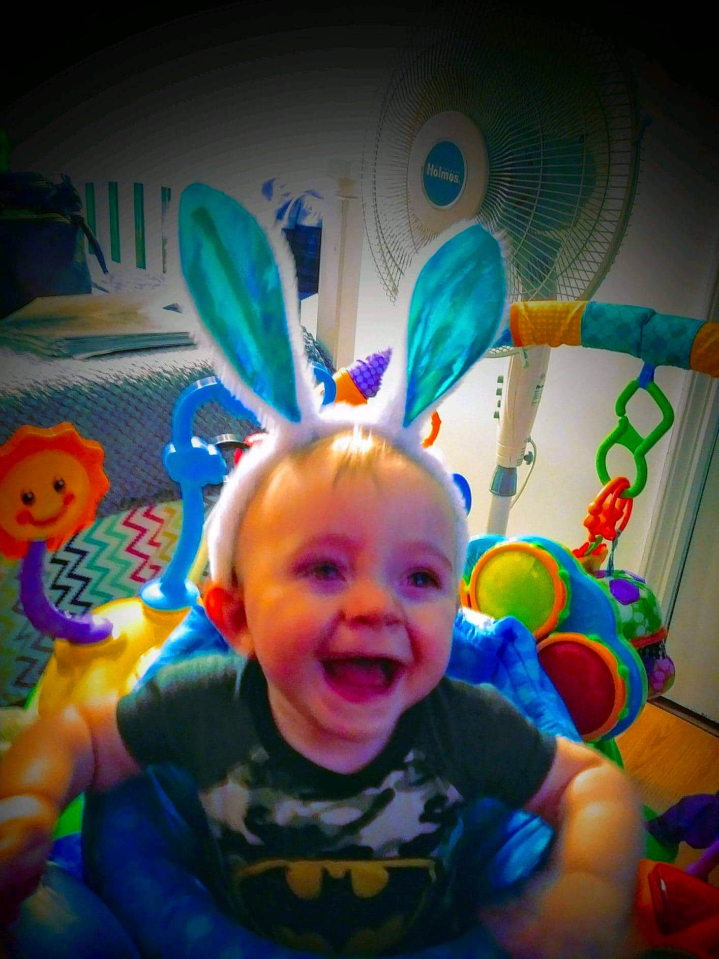 Gunner is registered to the contest to win money with this photo: baby, baby_toddler_clothing, baby_toys, child, event, facial_expression, fun, happy, inflatable, leisure, light, magenta, party_supply, person, play, smile, snapshot, t_shirt, toddler, toy