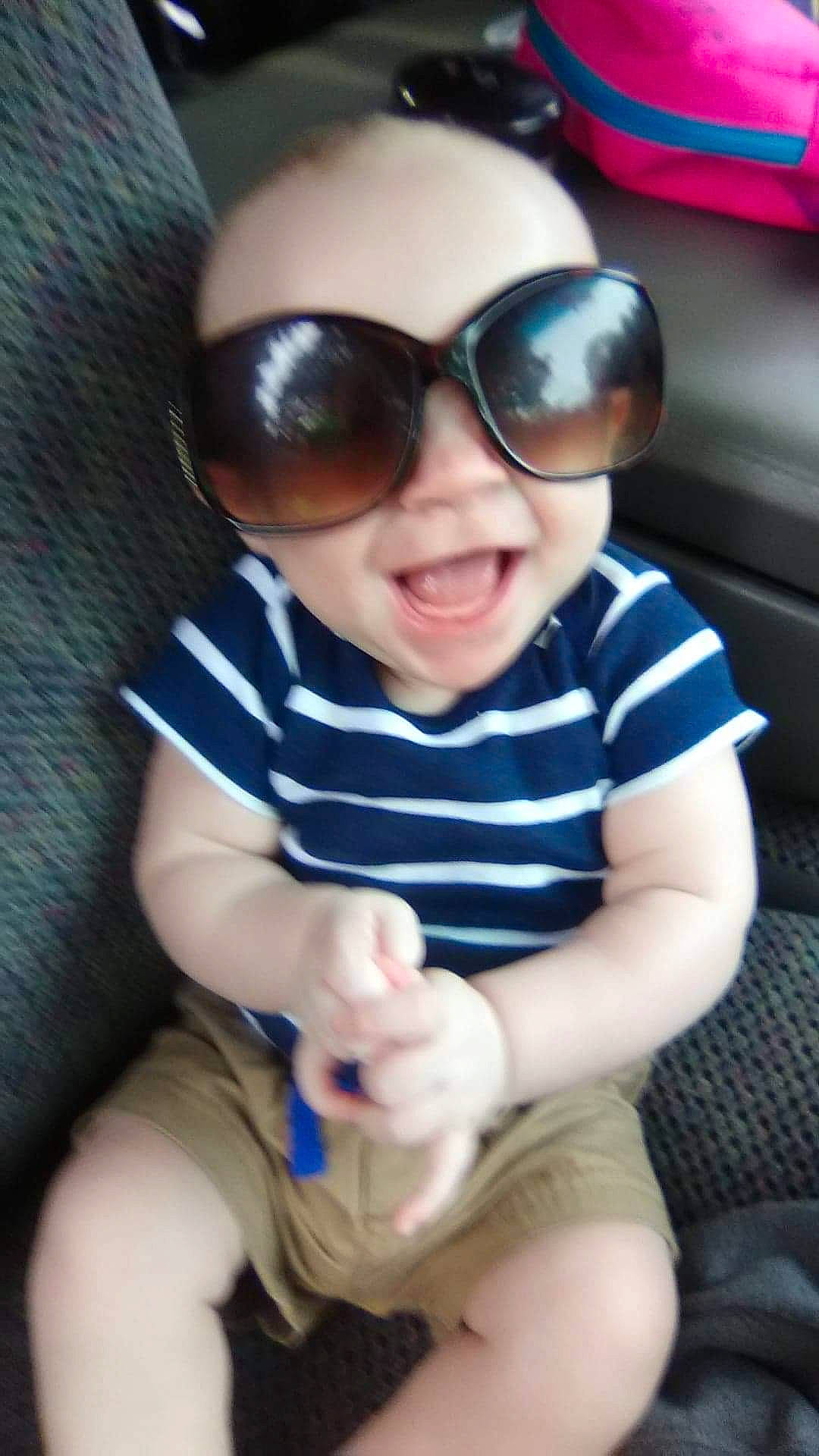 Gunner joined the competition — help win amazing prizes! auto_part, baby, baby_toddler_clothing, cheek, child, cool, electric_blue, eye_glass_accessory, eyewear, glasses, goggles, happy, lip, person, sitting, skin, sleeve, smile, sunglasses, toddler