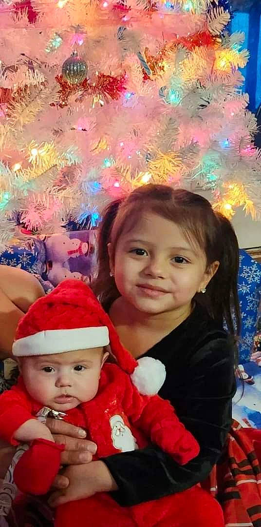 Krystella is registered to the contest to win money with this photo: baby_toddler_clothing, beauty, blue, cap, child, christmas, christmas_decoration, christmas_eve, event, face, facial_expression, fun, happy, headwear, holiday, joy, leisure, party_supply, person, photograph