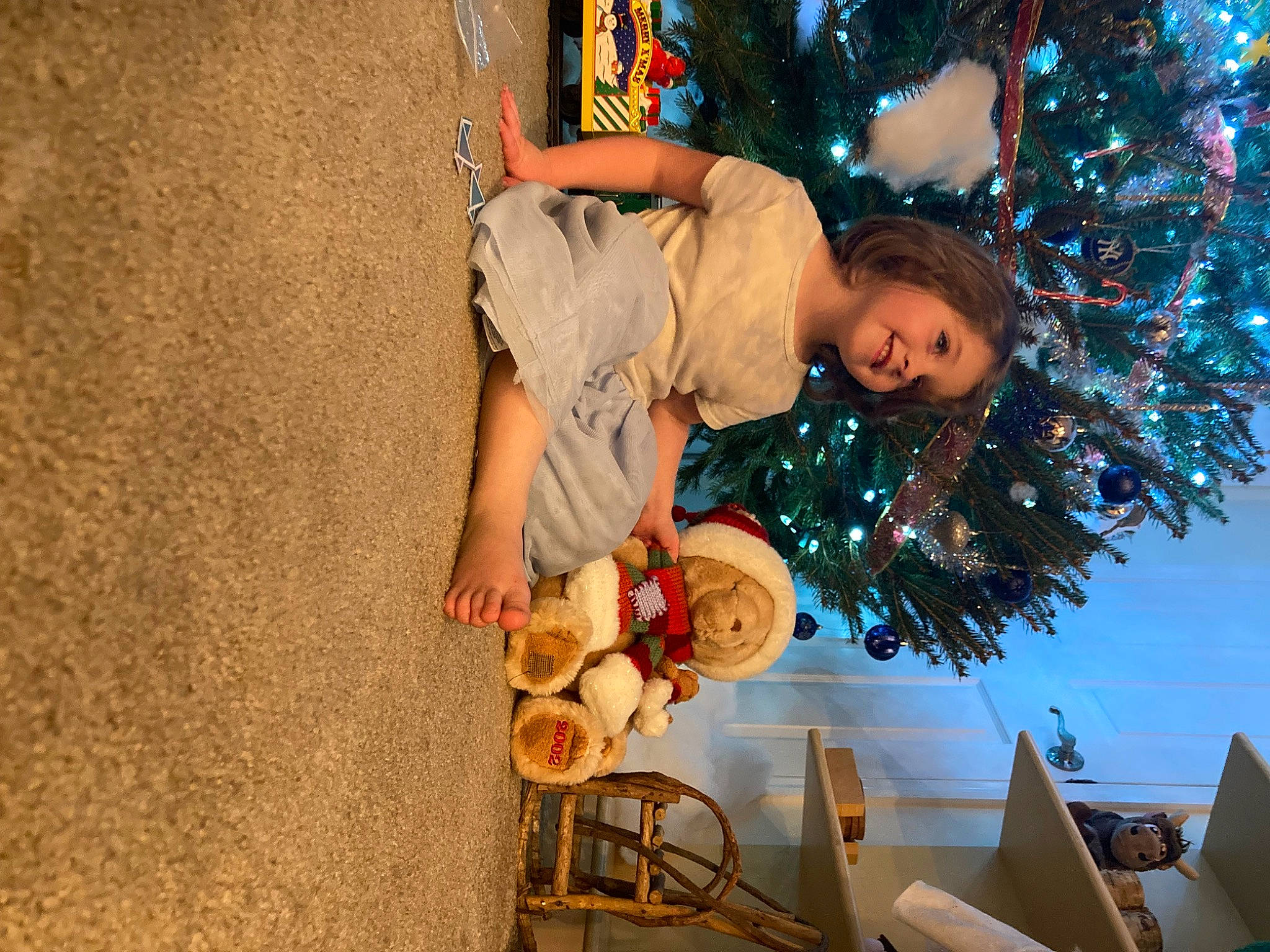 Amarah is registered to the contest to win money with this photo: child, christmas, christmas_decoration, christmas_eve, christmas_ornament, christmas_tree, event, fun, happy, holiday, holiday_ornament, joy, leisure, ornament, party_supply, person, plant, soil, teddy_bear, toddler