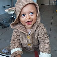 Marceau participe au concours pour gagner de l'argent avec cette photo : baby, blue_eyes, buttons, child, crawling, cute, expression, floor_tiles, furniture, hands, happy, hoodie, indoors, kitchen, knitted_clothing, modern, playful, smiling, socks, warm_clothing