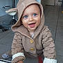 Marceau participe au concours pour gagner de l'argent avec cette photo : baby, child, smiling, knitted_clothing, hoodie, blue_eyes, crawling, indoors, floor_tiles, kitchen, furniture, modern, happy, cute, hands, buttons, socks, warm_clothing, playful, expression