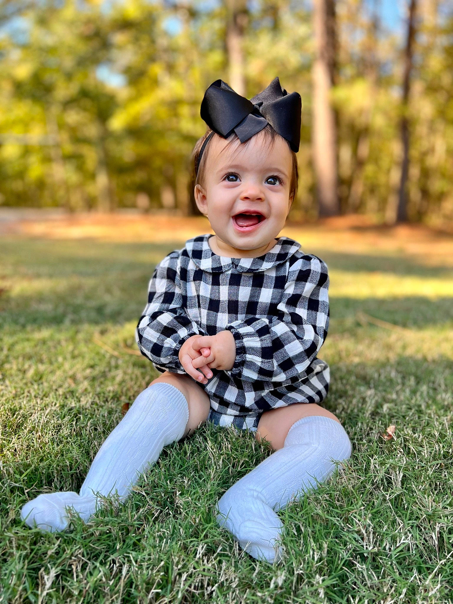 Mackenzie joined the competition — help win amazing prizes! baby, baby_toddler_clothing, child, eye, flash_photography, fun, grass, grassland, happy, headwear, pattern, people_in_nature, person, plant, sitting, sky, sleeve, smile, summer, sunlight