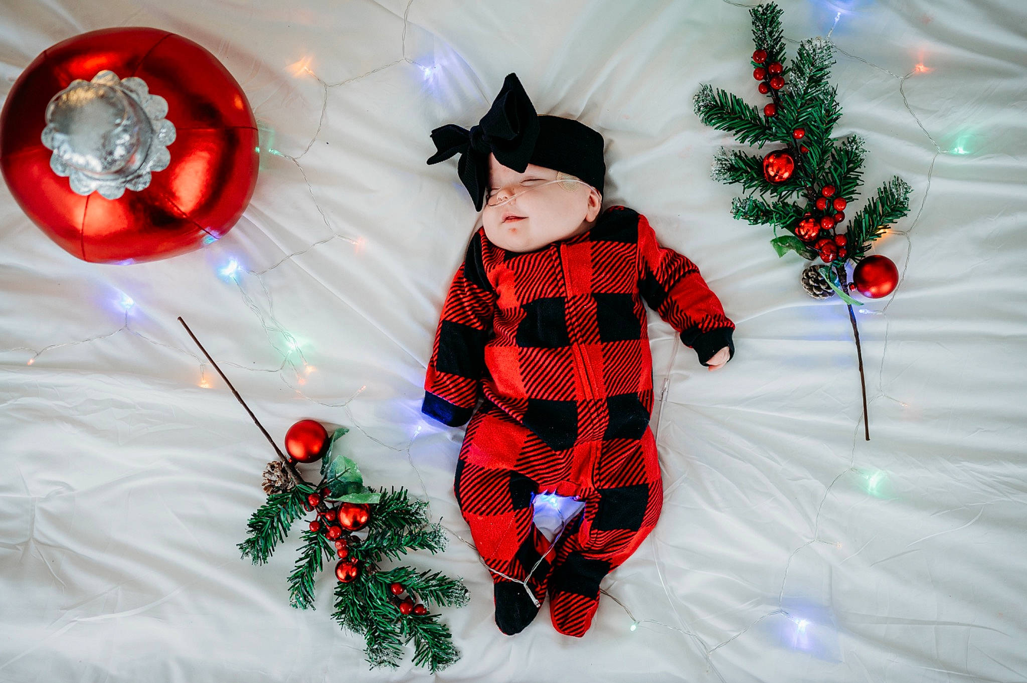 Novah is registered to the contest to win money with this photo: christmas_decoration, christmas_eve, christmas_ornament, costume_hat, facial_expression, freezing, fun, happy, head, holiday_ornament, human_body, lighting, mammal, ornament, outerwear, person, red, sleeve, snow, vertebrate