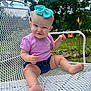 Gwendolyn is registered to the contest to win money with this photo: baby, child, outdoor, bench, metal, purple_shirt, denim_shorts, headband, bow, grass, flower, nature, smile, face, cute, happy, person, sitting, summer, playful