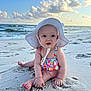 baby, beach, child, clouds, cute, footwear, nature, ocean, outdoor, pink_toenails, playful, sand, sitting, sky, summer, sunhat, sunshine, swimsuit, toddler, water