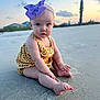 baby, beach, bow, child, clothing, clouds, cute, footwear, headband, nature, outdoor, palm_tree, portrait, purple, sand, sitting, sky, sunset, toes, vacation