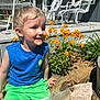 Jameson joined the competition — help win amazing prizes! child, boy, outdoor, flowers, rock, green_shorts, blue_shirt, sunlight, smiling, nature, garden, porch, white_chairs, plants, summer, casual_clothing, happy, daylight, sitting, portrait