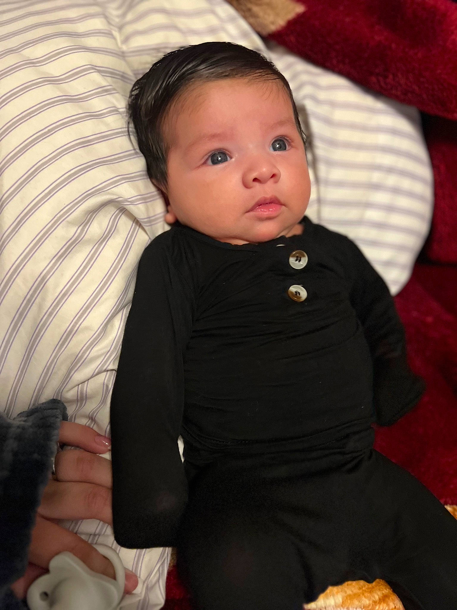 Mathias is registered to the contest to win money with this photo: baby, baby_toddler_clothing, cheek, child, comfort, couch, eye, flash_photography, fur, head, human_body, linens, nose, person, room, sitting, skin, sleeve, toddler, wood