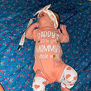 Hailey is registered to the contest to win money with this photo: baby, infant, girl, onesie, headband, pacifier, blanket, blue, floral, pattern, clothing, lying, cute, child, toddler, socks, legs, cute_outfit, closeup, indoors