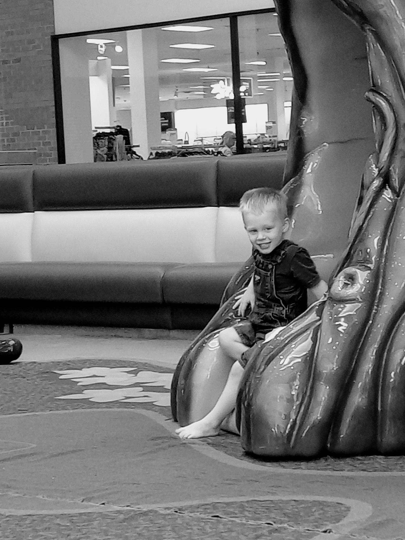 Liam is registered to the contest to win money with this photo: asphalt, black_and_white, child, city, comfort, fun, grey, human_leg, joy, leg, leisure, monochrome, monochrome_photography, person, playground_slide, recreation, road, road_surface, sidewalk, sitting