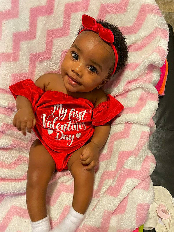 Lauren is registered to the contest to win money with this photo: baby, baby_toddler_clothing, cap, cheek, comfort, face, foot, fun, happy, human_leg, joy, knee, leg, lip, muscle, person, pink, shorts, skin, sleeve