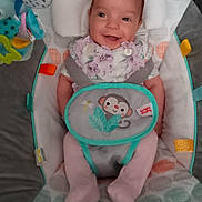 Lainey is registered to the contest to win money with this photo: baby, smiling, infant, child, bouncer, baby_seat, colorful, toy, animal_print, clothing, pastel_colors, happy, cute, indoor, fabric, seat, head_support, playtime, comfort, young_child