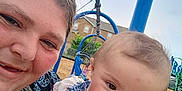 Estella joined the competition — help win amazing prizes! baby, woman, child, smiling, playground, swing, outdoor, daylight, person, blue, clothing, face, happy, holding, nature, sky, grass, family, casual, fun