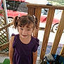 child, girl, pigtails, purple_shirt, smile, pet, dog, porch, wooden_rail, red_car, bucket, outdoor, grass, daylight, casual_clothing, happy, person, animal, playful, summer