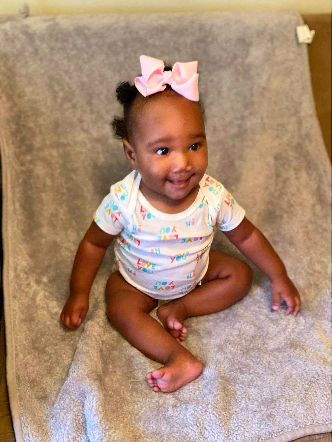 Kaitlyn joined the competition — help win amazing prizes! baby, baby_products, baby_toddler_clothing, child, hair_accessory, head, headband, headgear, joy, person, pink, play, product, sitting, skin, smile, t_shirt, toddler