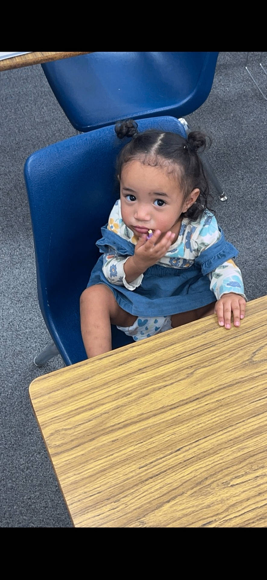 Nyla-Avery is registered to the contest to win money with this photo: bodypart, child, clothing, cutlery, face, female, finger, furniture, girl, hand, hardwood, head, pants, person, photography, plywood, portrait, sitting, spoon, wood