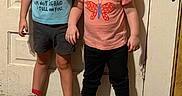 Payslee joined the competition — help win amazing prizes! toddler, child, standing, door, blue_shirt, butterfly_shirt, shorts, pants, sneakers, socks, indoor, wood_floor, curly_hair, smile, funny_text, cute, people, clothing, wall, young