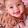 Octavia participe au concours pour gagner de l'argent avec cette photo : baby, child, smiling, tongue_out, cozy_clothing, brown_sweater, closeup, face, cheerful, cute, infant, portrait, soft_lighting, bokeh, indoors, happy, skin, hand, eyes, young