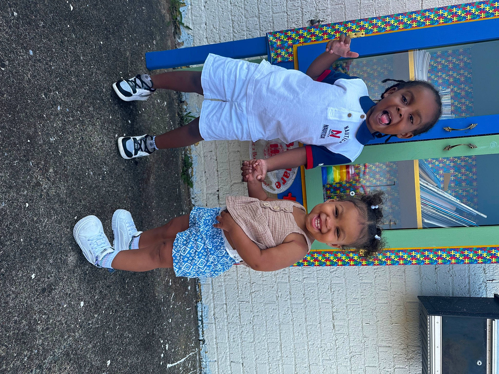 Nora is registered to the contest to win money with this photo: asphalt, baby_toddler_clothing, child, concrete, electric_blue, foot, fun, happy, human_leg, joy, leisure, pattern, person, play, road_surface, room, shadow, sidewalk, smile, toddler