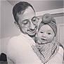 baby, child, man, glasses, head_wrap, smile, indoor, portrait, holding, affection, love, happy, cute, family, together, warmth, clothing, face, person, black_and_white