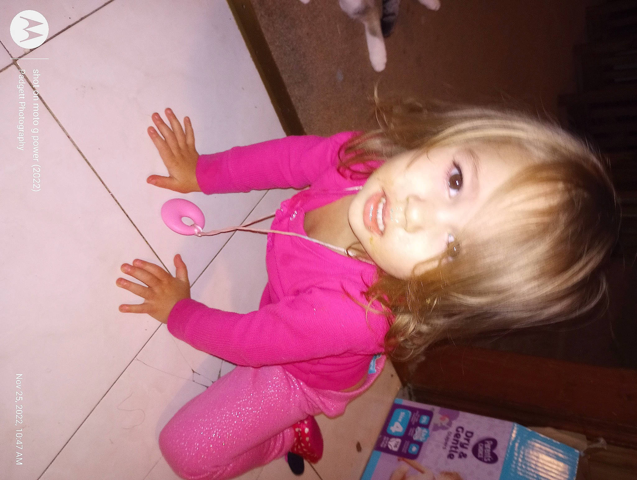 Jazmyn is registered to the contest to win money with this photo: baby, baby_toddler_clothing, cheek, child, finger, flooring, fun, gesture, happy, magenta, nail, person, pink, play, room, skin, smile, thumb, toddler, wood