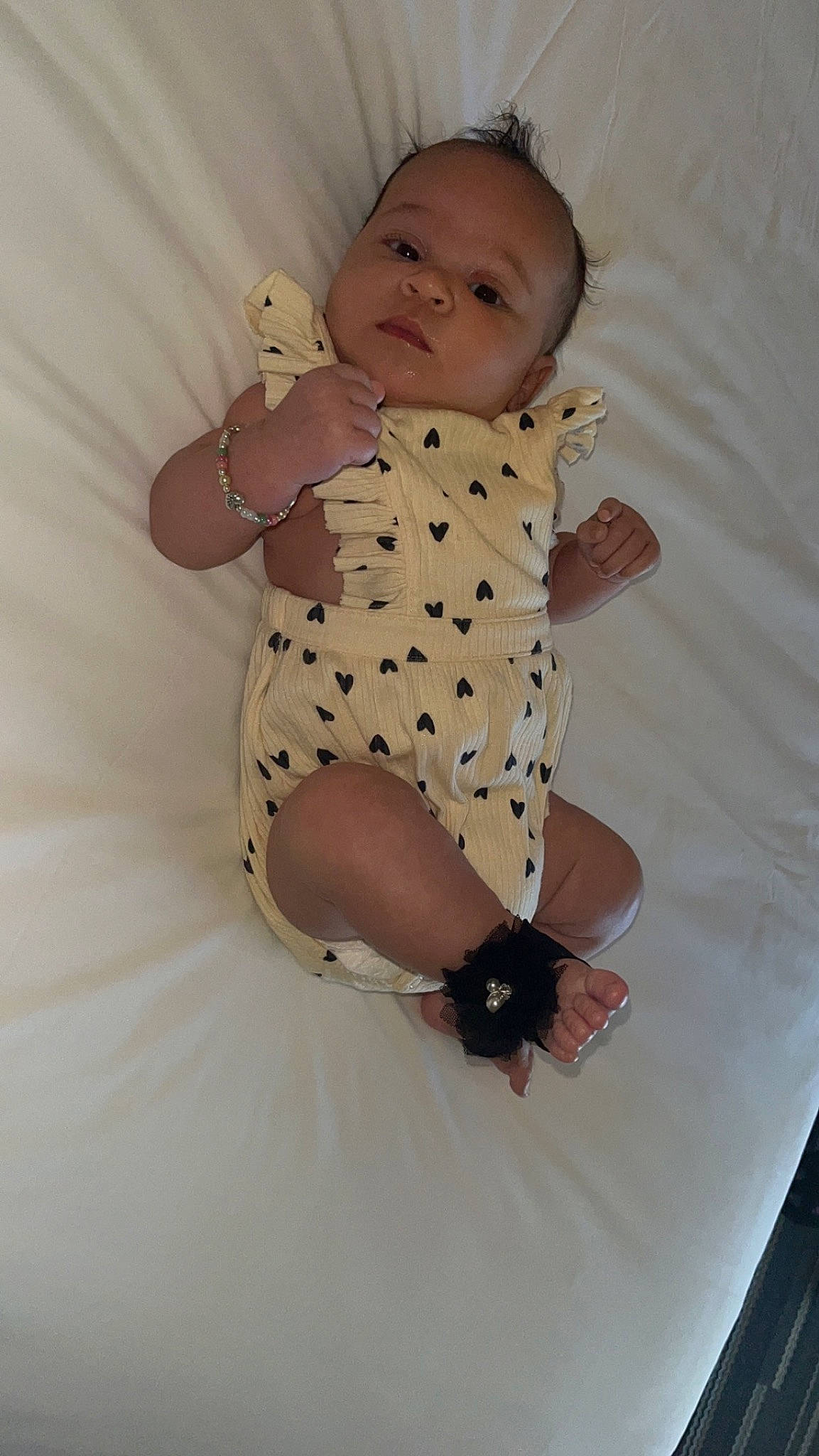 Kennedi joined the competition — help win amazing prizes! arm, baby, baby_toddler_clothing, child, comfort, day_dress, dress, face, head, human_body, human_leg, knee, leg, linens, one_piece_garment, pattern, person, skin, sleeve, thigh