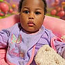 Shaiah is registered to the contest to win money with this photo: baby, background, bib, blanket, chair, child, clothing, cushion, cute, expression, face, fluffy, green, indoor, person, pink, portrait, purple, seated, soft