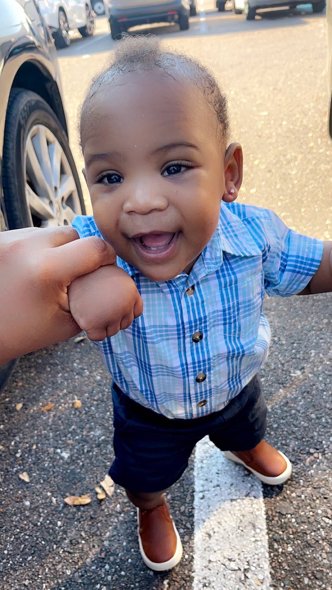 Kyree is registered to the contest to win money with this photo: asphalt, automotive_tire, child, chin, cool, electric_blue, fun, gesture, grass, hairstyle, happy, leisure, person, plaid, public_space, skin, smile, t_shirt, tire, toddler