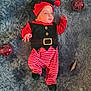 baby, infant, child, christmas_ornaments, elf_costume, striped_pants, festive, holiday, soft_rug, red, green, cute, lying_down, decorations, celebration, seasonal, festivity, indoors, portrait, festive_hat