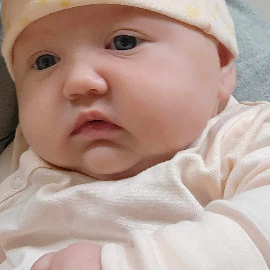 Phenoix joined the competition — help win amazing prizes! baby, child, closeup, clothing, cute, expression, face, hand, hat, holding, indoors, infant, newborn, peaceful, person, portrait, skin, soft, warm, young