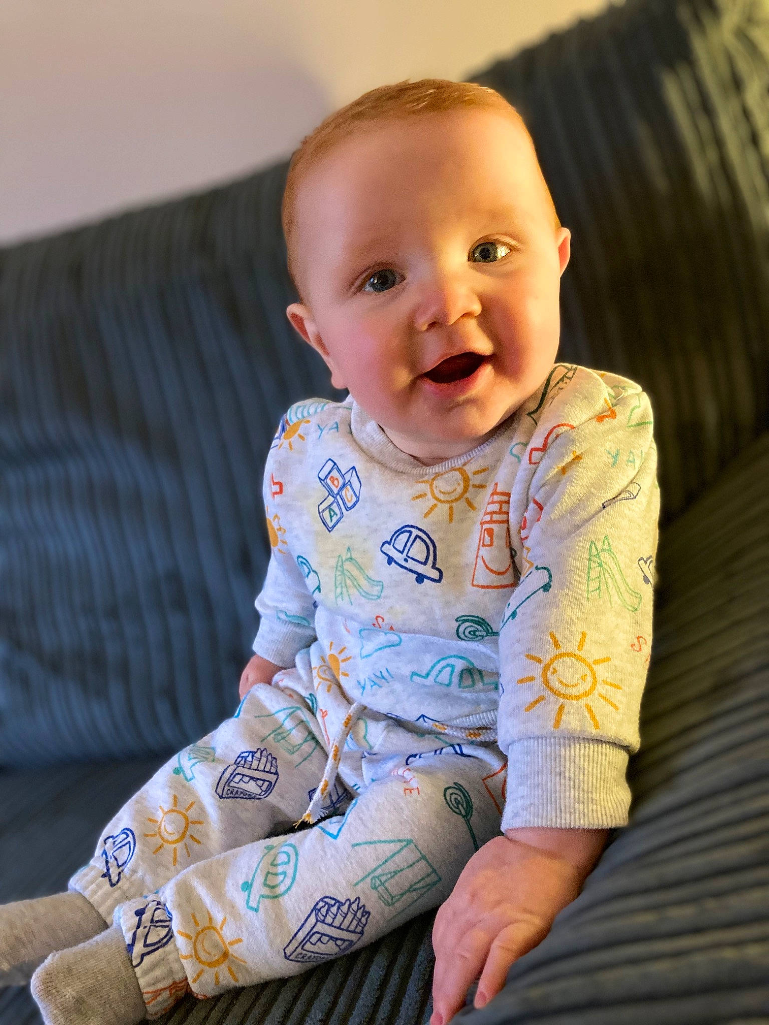 Kohen joined the competition — help win amazing prizes! baby, baby_toddler_clothing, cheek, child, chin, collar, comfort, couch, eye, face, facial_expression, flooring, happy, iris, pattern, person, sitting, skin, sleeve, smile