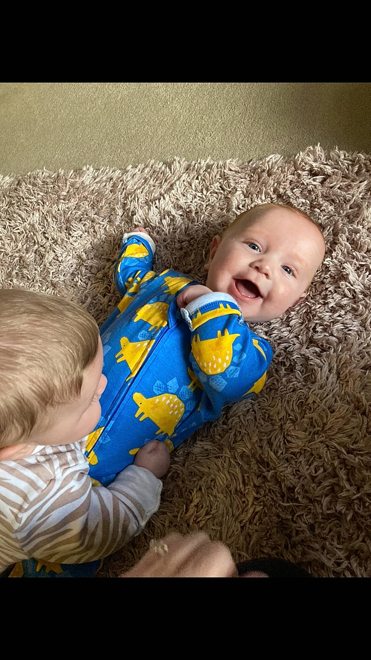 Kohen is registered to the contest to win money with this photo: baby, baby_toddler_clothing, cheek, comfort, flash_photography, flooring, fun, grass, hairstyle, happy, iris, nose, pattern, people_in_nature, person, product, sitting, skin, smile, textile