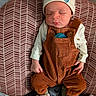 baby, bear_slippers, child, clothing, corduroy, cushion, cute, footwear, hat, indoors, infant, newborn, overalls, pattern, peaceful, person, resting, sleeping, small_hand, soft_lighting