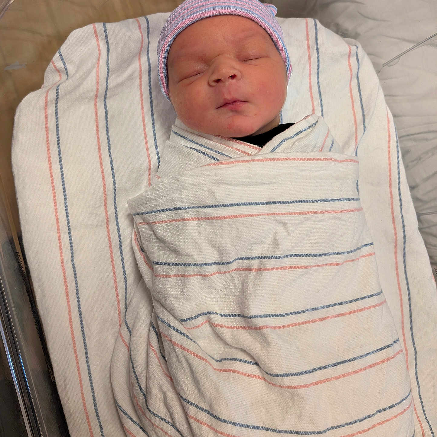 Aelius joined the competition — help win amazing prizes! baby, bassinet, bed, blanket, cap, closeup, face, headwear, healthcare, hospital, infant, newborn, nursery, peaceful, person, resting, skin, sleeping, striped, swaddled