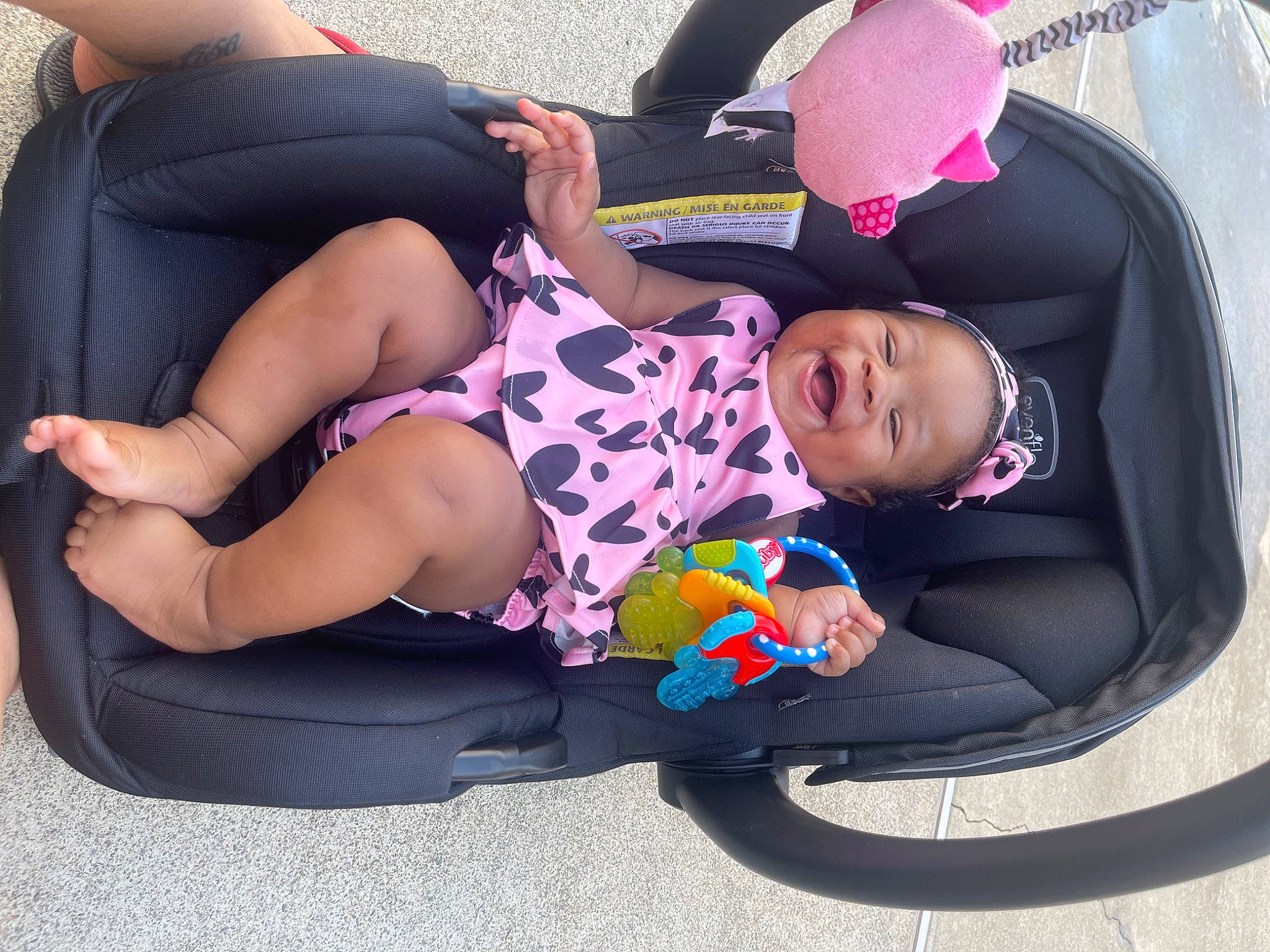 Skylar is registered to the contest to win money with this photo: baby, baby_carriage, baby_products, baby_toddler_clothing, child, comfort, foot, fun, human_leg, knee, lap, leg, leisure, person, pink, shorts, sitting, sneakers, sock, thigh
