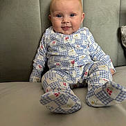 Maddie joined the competition — help win amazing prizes! baby, child, pajamas, blue, white, floral, pattern, smile, face, couch, furniture, indoor, cute, infant, sitting, comfort, happy, young, portrait, cozy