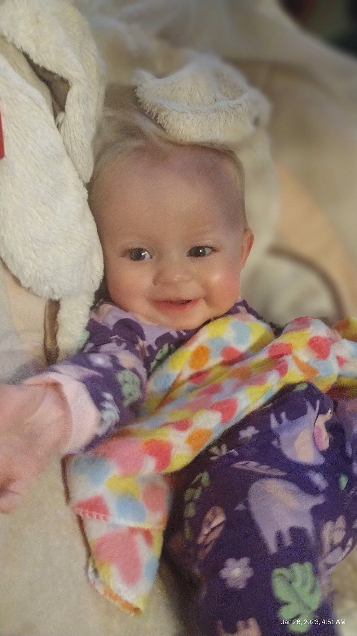 Journey is registered to the contest to win money with this photo: arm, baby, baby_toddler_clothing, cheek, child, comfort, eye, happy, hat, headgear, human_body, iris, joy, linens, nose, person, pink, skin, sleeve, smile