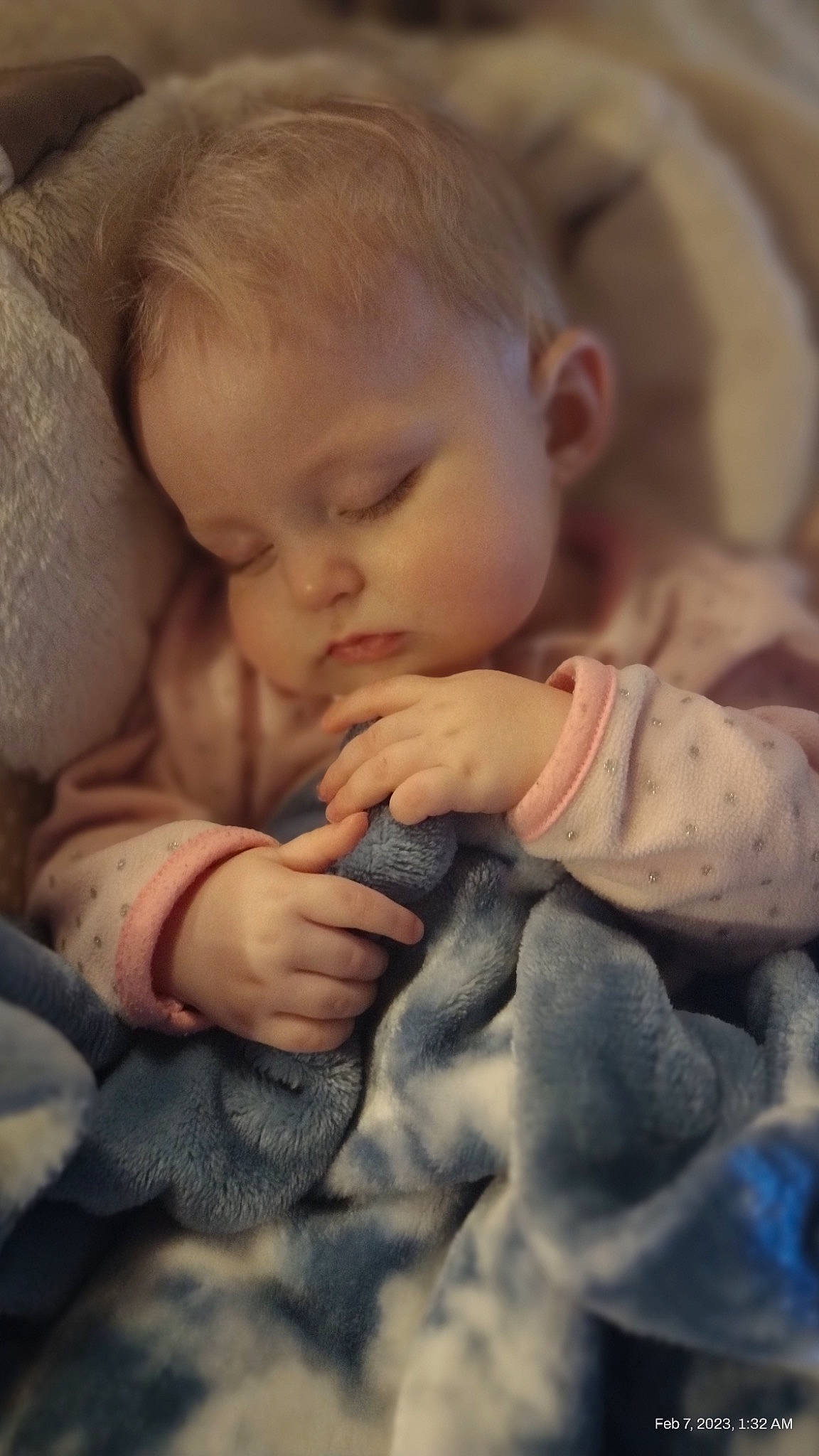 Journey is registered to the contest to win money with this photo: arm, baby, baby_toddler_clothing, cheek, child, comfort, eye, eyebrow, finger, gesture, hand, iris, linens, lip, mouth, nail, nose, person, skin, thumb