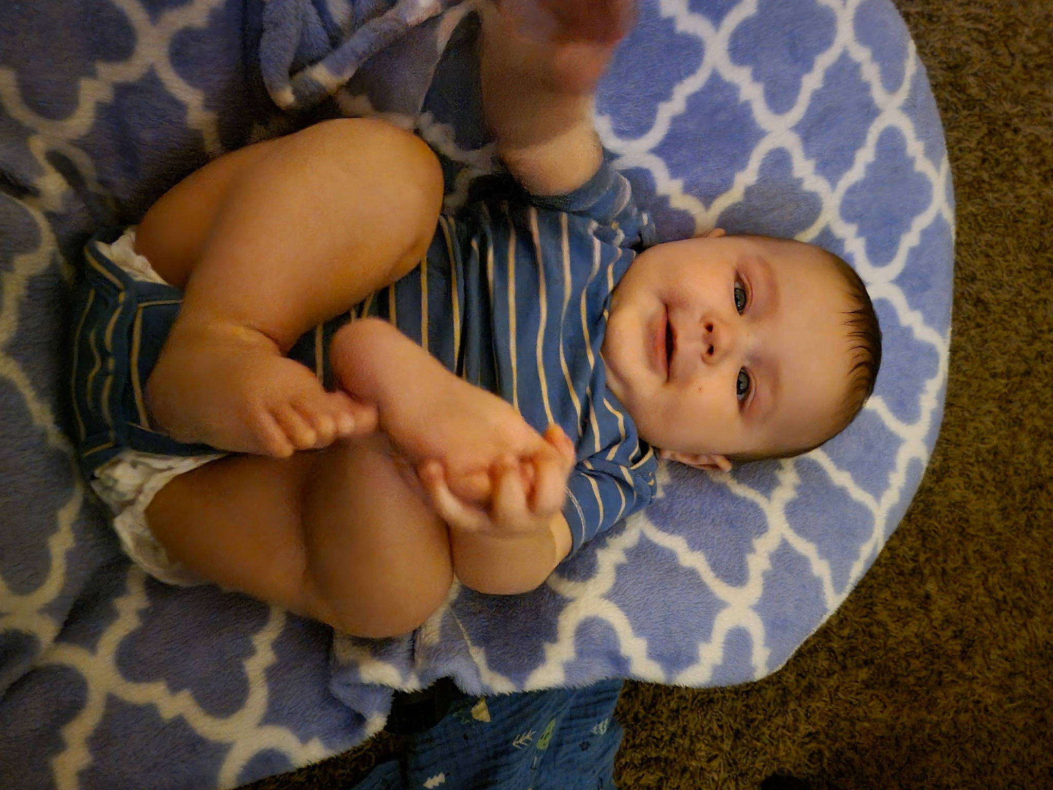 Abel is registered to the contest to win money with this photo: baby, baby_products, baby_toddler_clothing, cheek, child, comfort, eye, finger, foot, grass, human_leg, knee, linens, pattern, person, sitting, skin, sleeve, thigh, toddler