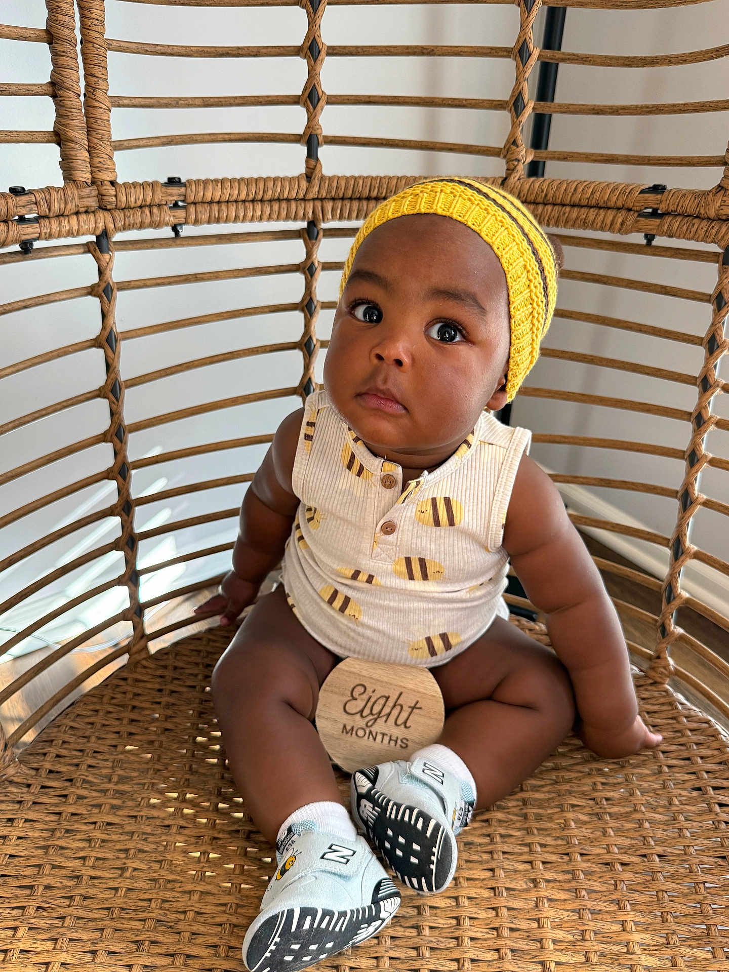 Noah joined the competition — help win amazing prizes! baby, infant, eight_months_sign, rattan_chair, wicker, yellow_hat, onesie, sneakers, portrait, cute, big_eyes, sitting, home_interior, wooden_milestone, soft_lighting, cute_expression, closeup, natural_light, basket_chair, chubby_legs
